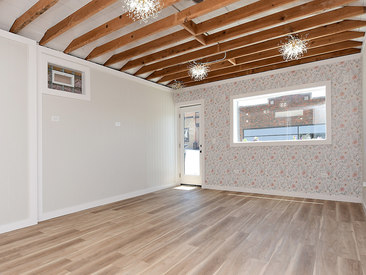 Inside The Studio Springfield — exposed beam ceiling, sparkle chandeliers, and open floor space